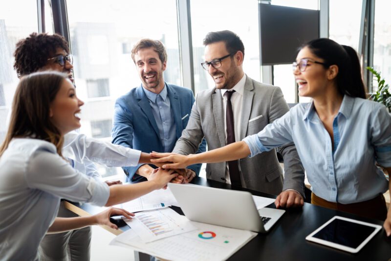 Business team celebrating a good job in the modern office